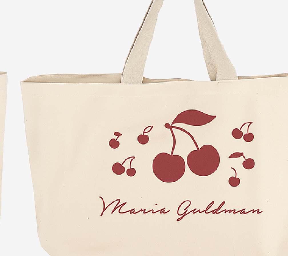 Bolso de tela con la ilustración de cerezas en rojo.